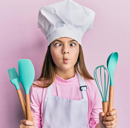 Treat Beauty Birthday Cake Jumbo Organic Lip Balm. Birthday Cake flavored lip balm in a jumbo size tube. Girl making a funny face and holding baking tools. 